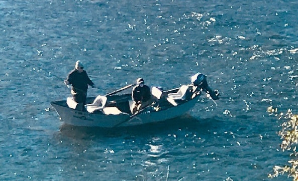 2 men fishing in boat
